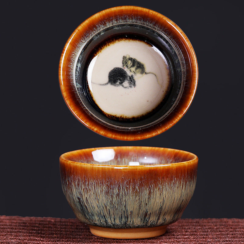12 Zodiac Jian Zhan Teacup - Rat zodiac dual view with ink-wash mice interior and amber crystalline exterior glaze pattern