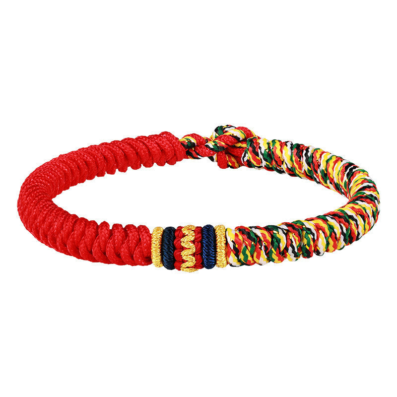 Tibetan five-color king kong knot braid bracelet on white background showing red cord base rainbow multicolor weave gold metallic accents and adjustable sliding knot