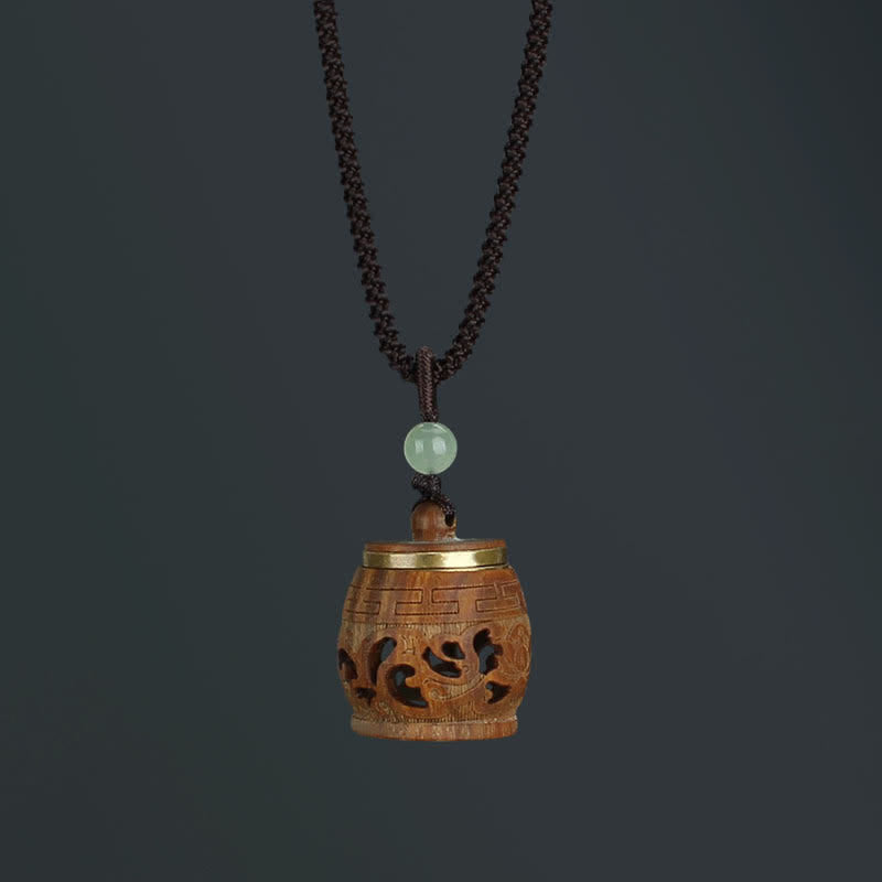 Om Mani Padme Hum Necklace – Drum-shaped wooden pendant with Greek key border and cloud scroll openwork, jade bead