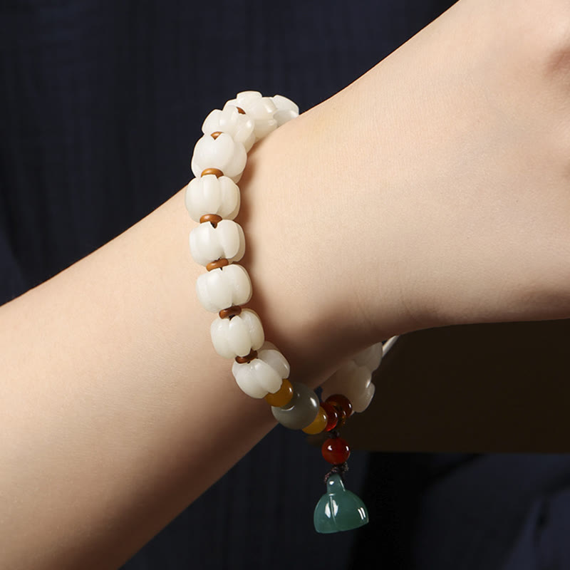 Bodhi Seed Lotus Bead Bracelet - on wrist, white lotus beads and red agate accents