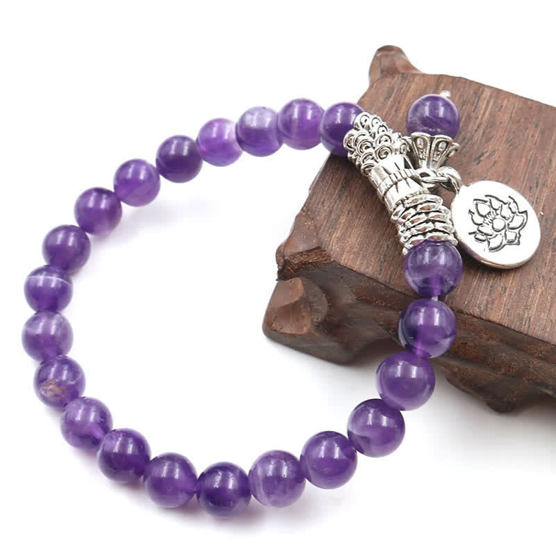Amethyst Lotus Bracelet - on rustic wooden stand, silver lotus charm and purple beads, boho