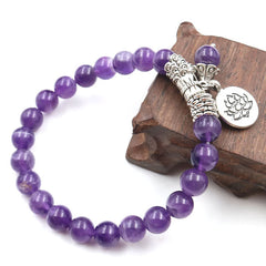 Amethyst Lotus Bracelet - on rustic wooden stand, silver lotus charm and purple beads, boho