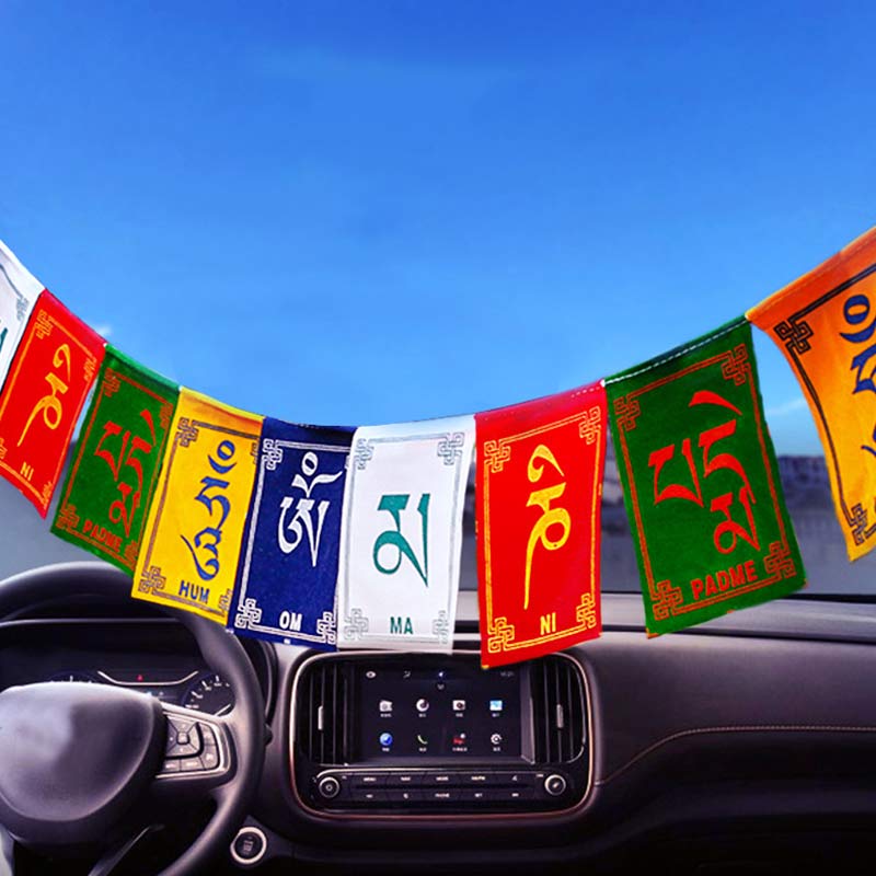 Tibetan Prayer Flags – Mini flags hanging on car windshield with dashboard and blue sky, car spiritual decor