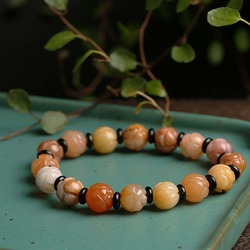 Golden Silk Jade Lotus Bracelet – Warm lotus carved beads with black spacers on celadon dish with leaves, jade bracelet