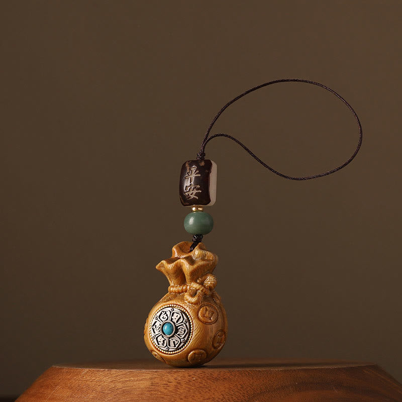 Sandalwood Money Bag Mantra Hanging - Dark wood bag with turquoise center, ornament