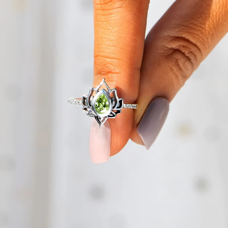 Sterling Silver Lotus Ring – Green peridot on hand with pink nails, lotus jewelry
