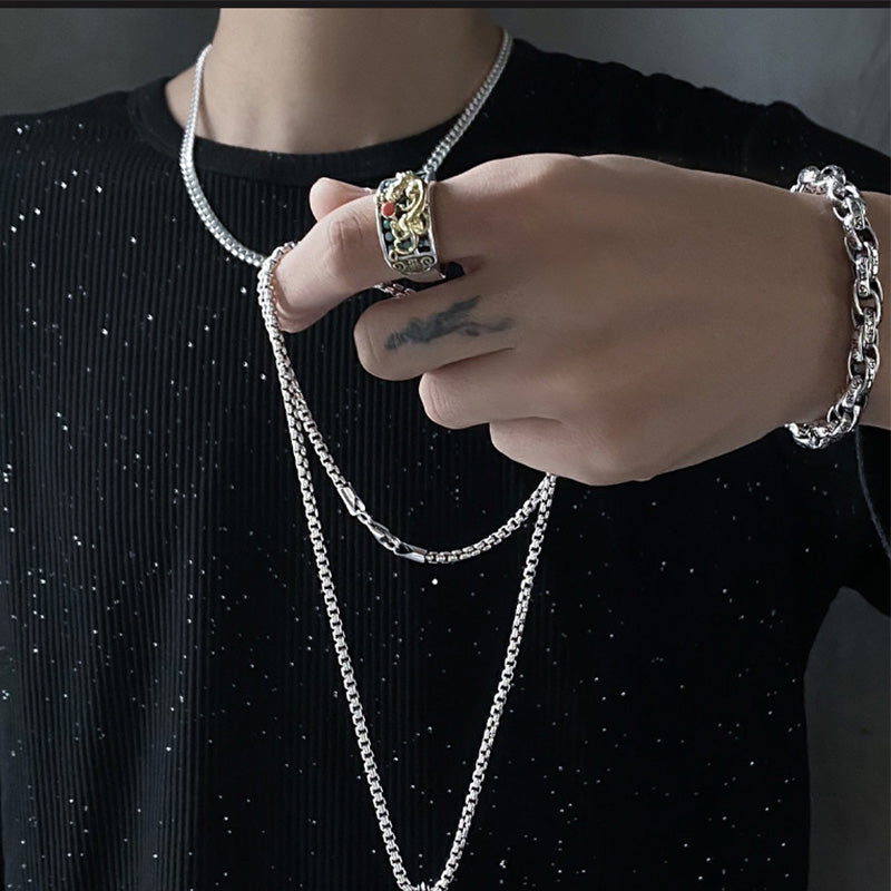 Silver PiXiu Ring – Man wearing with silver chains and bracelet, black ribbed shirt, bold men's jewelry