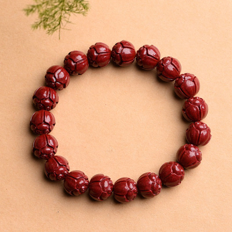 Cinnabar Om Mani Padme Hum Bracelet – lotus petal carved red beads flat lay, cinnabar lotus jewelry
