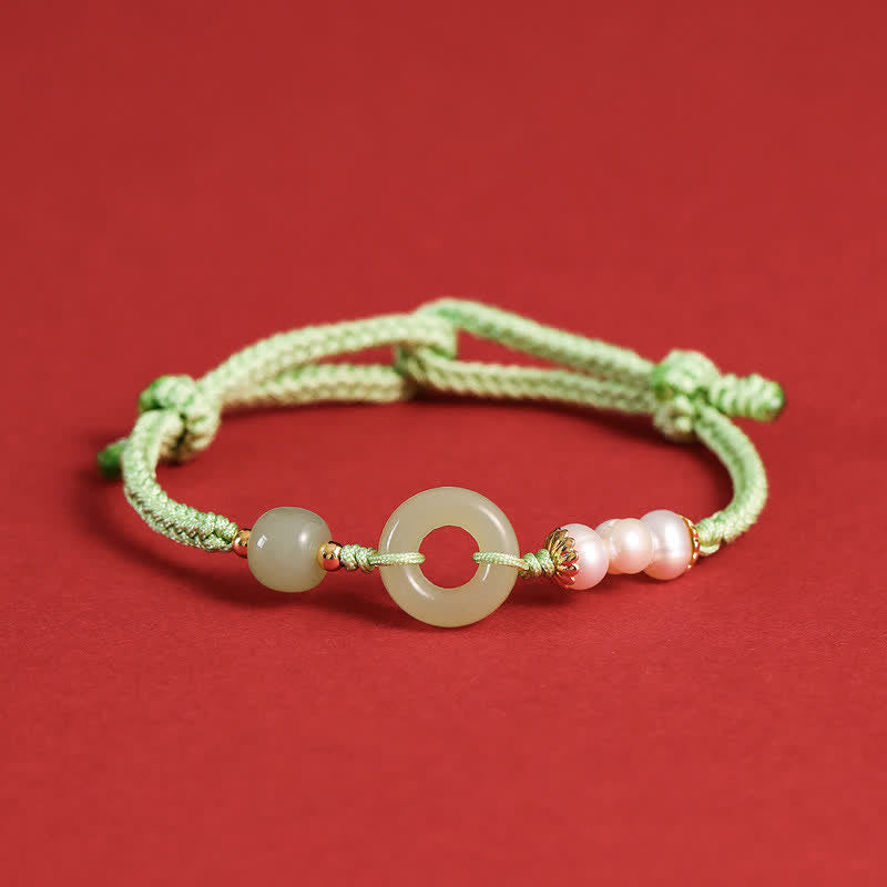Hetian Jade Pearl Peace Buckle Bracelet – mint green cord with jade disc pink pearls and red enamel spacers, crimson background