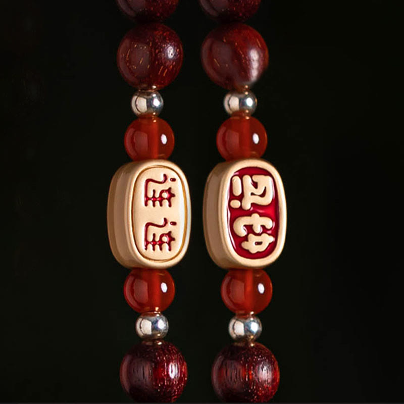Red Sandalwood Car Hanging – Polished red sandalwood beads with natural wood grain in shallow focus, sandalwood prayer beads