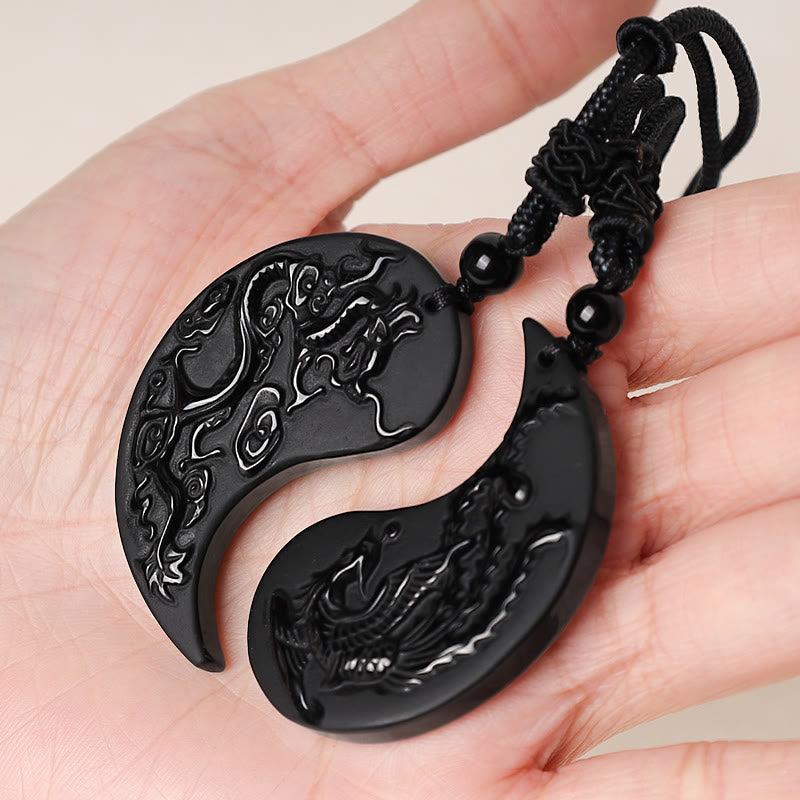 Black Obsidian Dragon Phoenix Necklace - Dragon phoenix yin yang pendant held in open palm, Balance