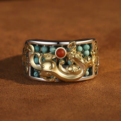 Silver PiXiu Ring – 925 silver band with gold PiXiu, turquoise beads, red agate center, brown suede background