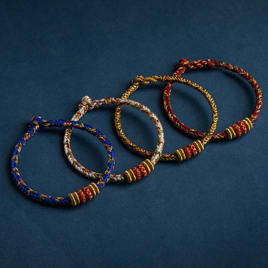 Set of four handmade braided cord bracelets in blue cream gold and red, with red gold accent beads, adjustable knot closure spiritual protection jewelry