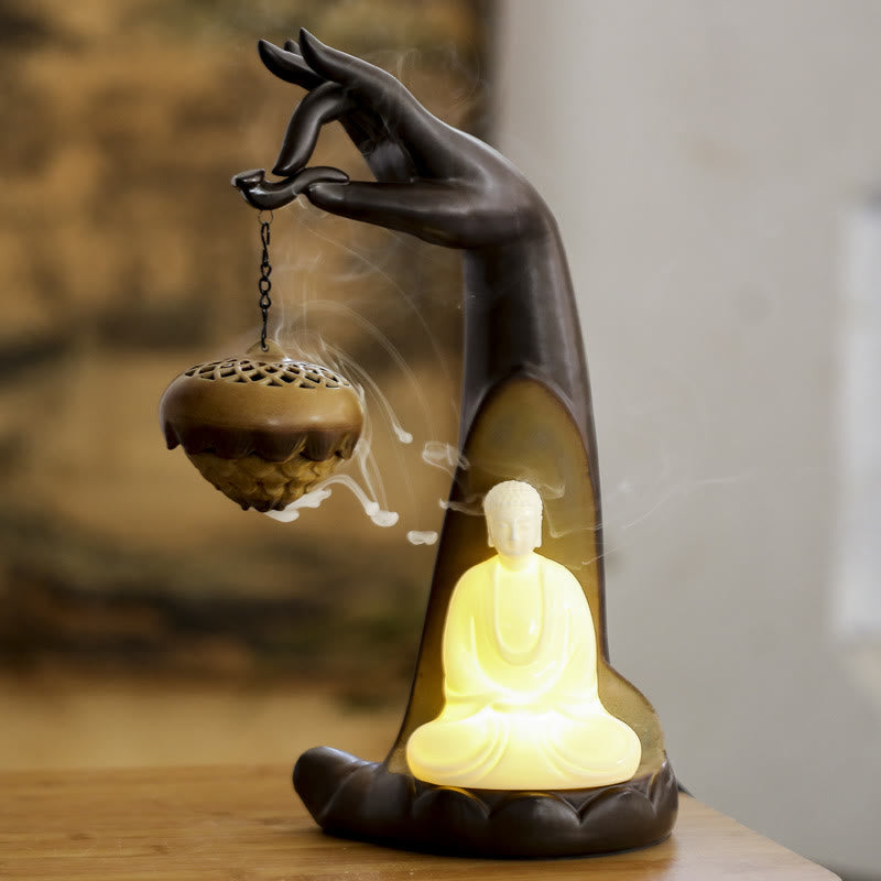 LED Buddha Hand Backflow Burner - warm LED glow and backflow smoke on wood surface