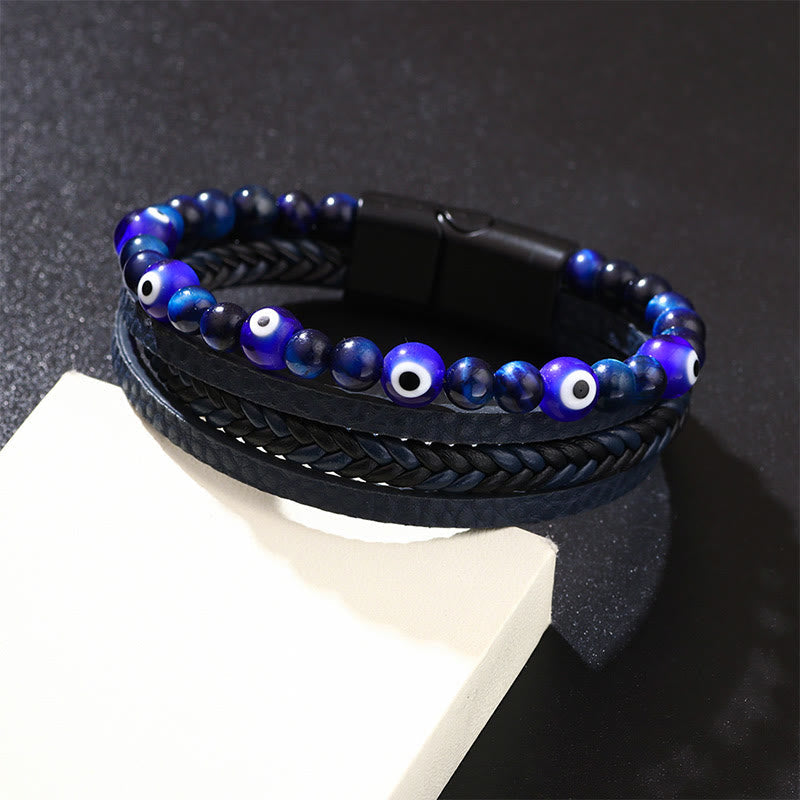 Evil Eye Tiger Eye Bracelet – Blue nazar beaded leather bracelet on white prop, dark studio background