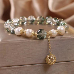 Green Phantom Pearl Charm Bracelet – Green phantom quartz white pearls gold floral spacers with filigree ball dangle, wood surface champagne silk, low side