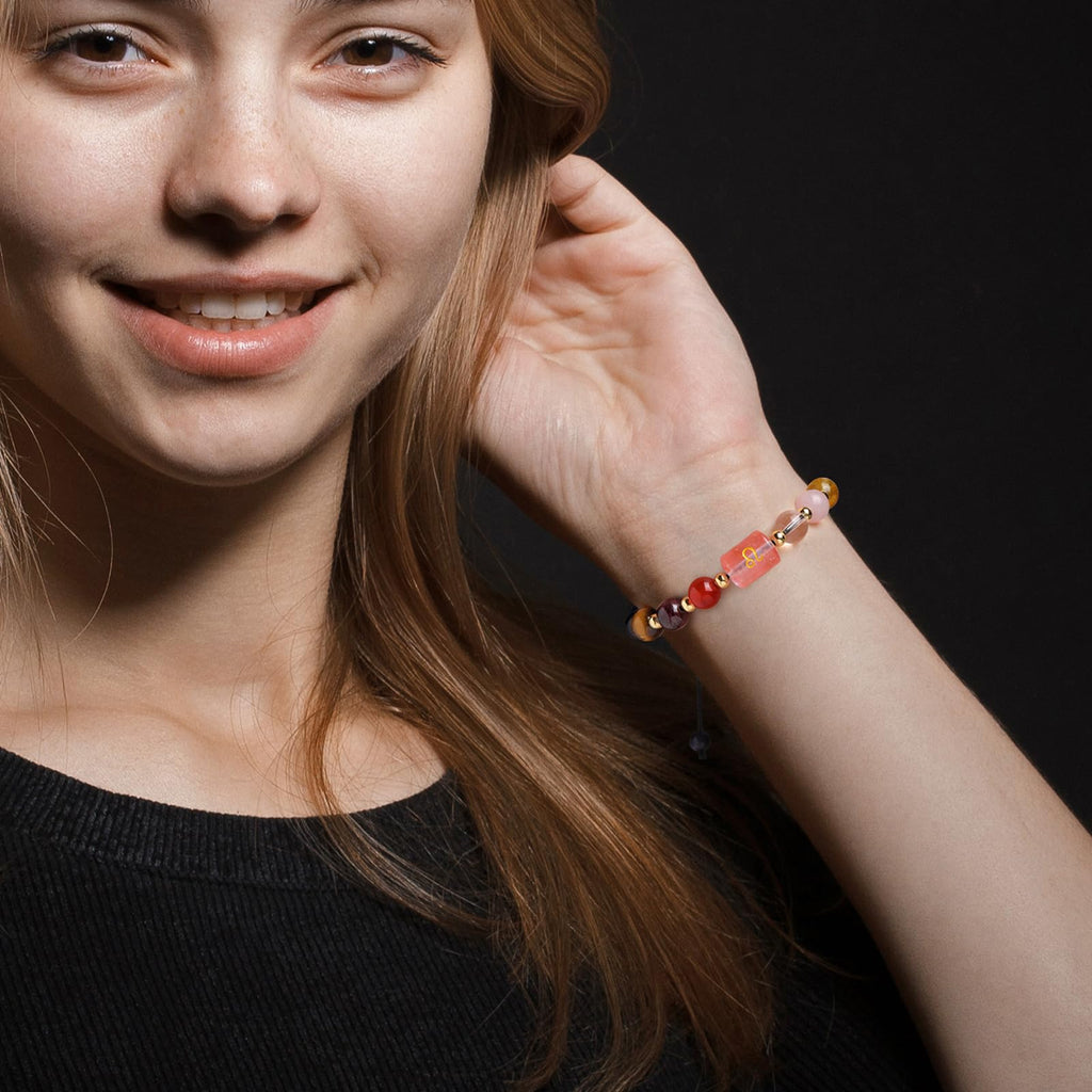 Zodiac Crystal Bracelet – worn on wrist of model, Libra symbol visible on pink bead