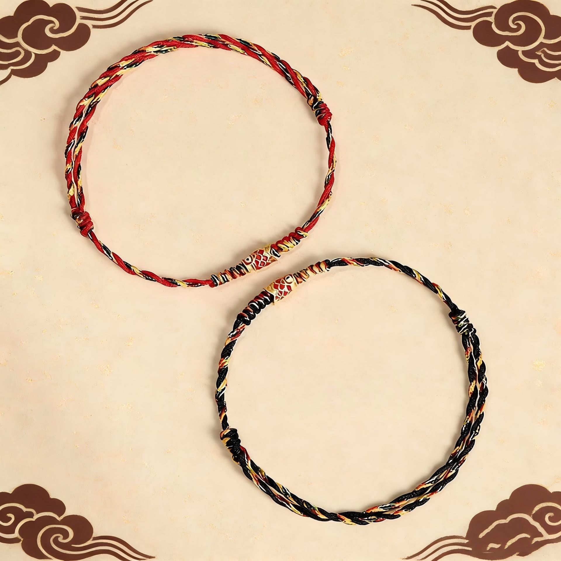 Five-Color Koi Bracelet – red and black pair of braided koi bracelets on cream background with cloud motifs, matching set