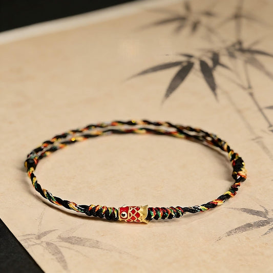 Five-Color Koi Bracelet – black multicolor woven cord with gold fish charm on bamboo art background, spiritual accessory