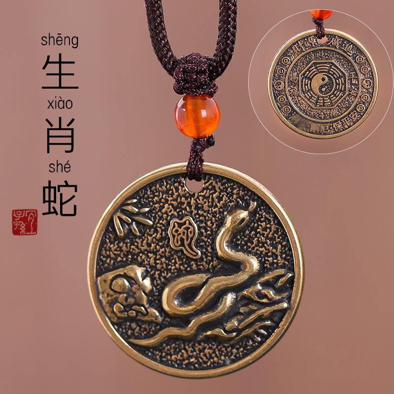Zodiac Bagua Pendant – brass snake disc with bamboo motif, red bead accent, spiritual jewelry