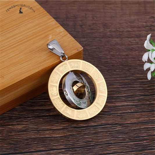 Zodiac Spin Necklace – side view triple layer structure, gold outer silver middle gold inner ring, wood surface white flower accent
