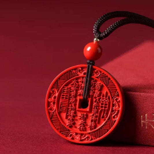 Cinnabar Pendant – bright red carved amulet with ancient symbols, red silk background, lucky talisman