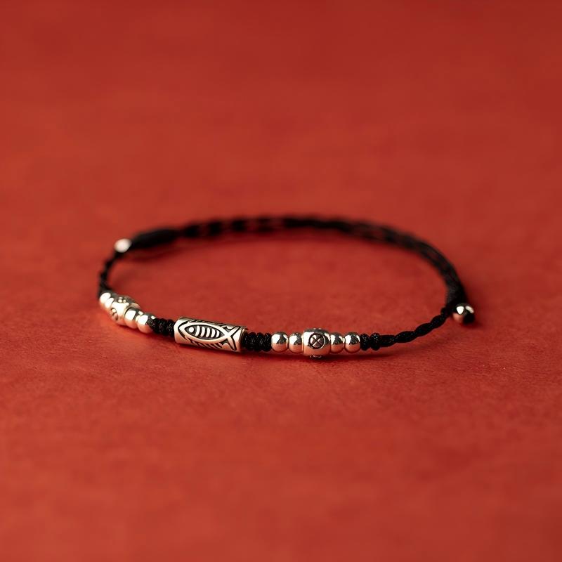 Koi Red String Bracelet – black woven cord with silver koi centerpiece and metal beads on red background, unisex accessory