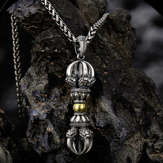 Tibetan Vajra Dorje Pendant Necklace – Oxidized silver with gold lotus accents and ornate filigree, dark volcanic rock backdrop