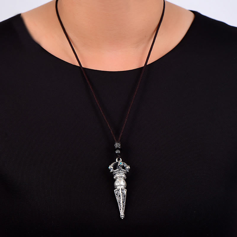 Tibetan Dorje Vajra Rotatable Pendant – Silver vajra pendant worn on model in white studio background, frontal view showing turquoise accents and filigree