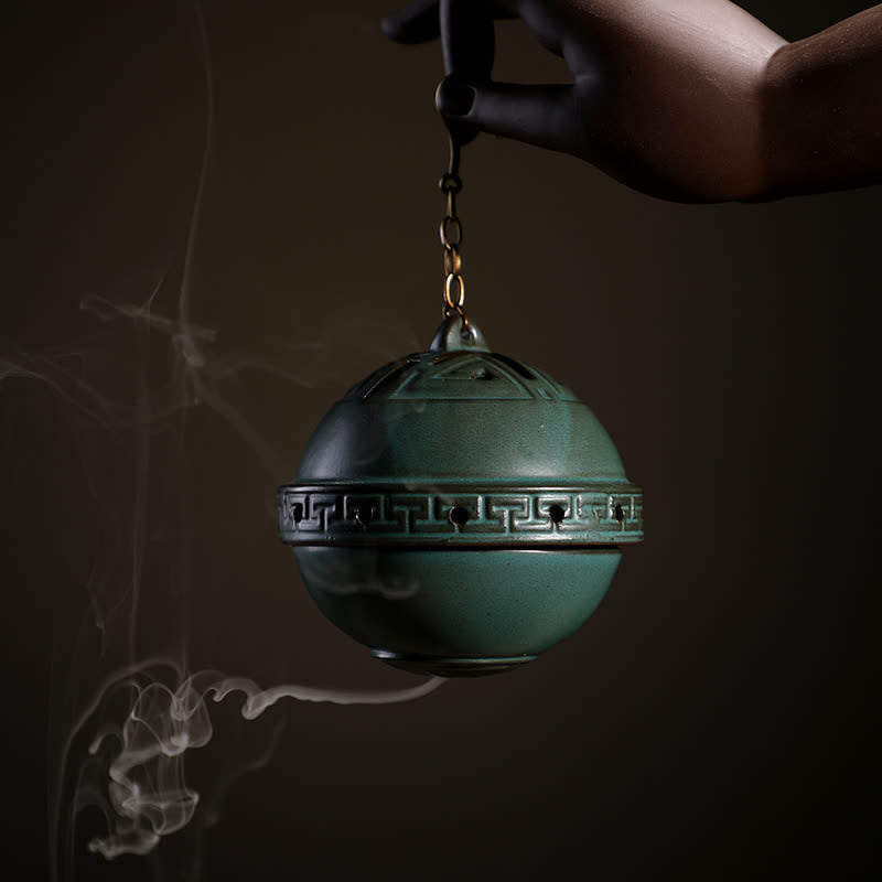 Tibetan Lotus Ceramic Incense Burner – close-up green sphere censer with Greek key band in hand, Meditative