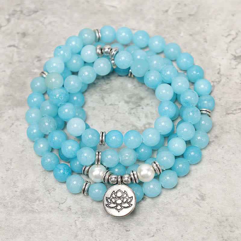 Amazonite Lotus Mala Bracelet wrapped flat lay with blue beads and silver lotus charm, healing