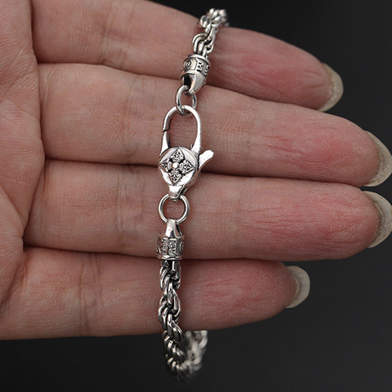 Silver Mantra Bracelet – worn on wrist with ornate floral clasp, oxidized silver, men's jewelry