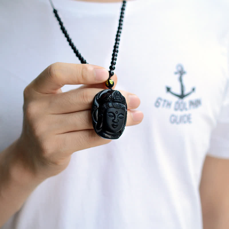 Black Obsidian Avalokitesvara Pendant - model holding carved Guanyin amulet, close-up detail, Shielding