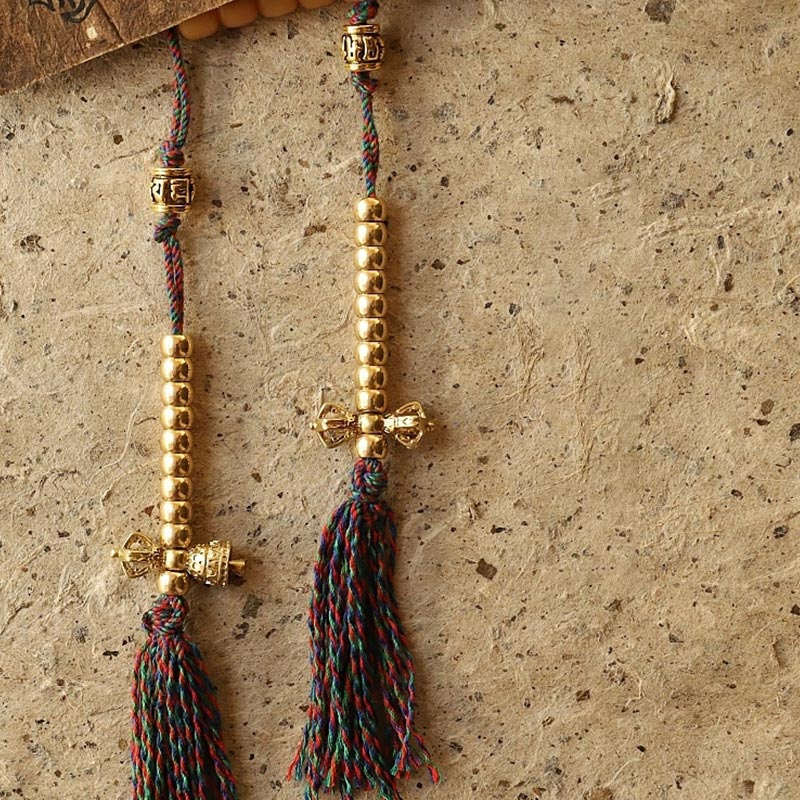 108 Bodhi Seed Mala Bracelet – Pair of dorje tassel counters with gold beads on handmade paper