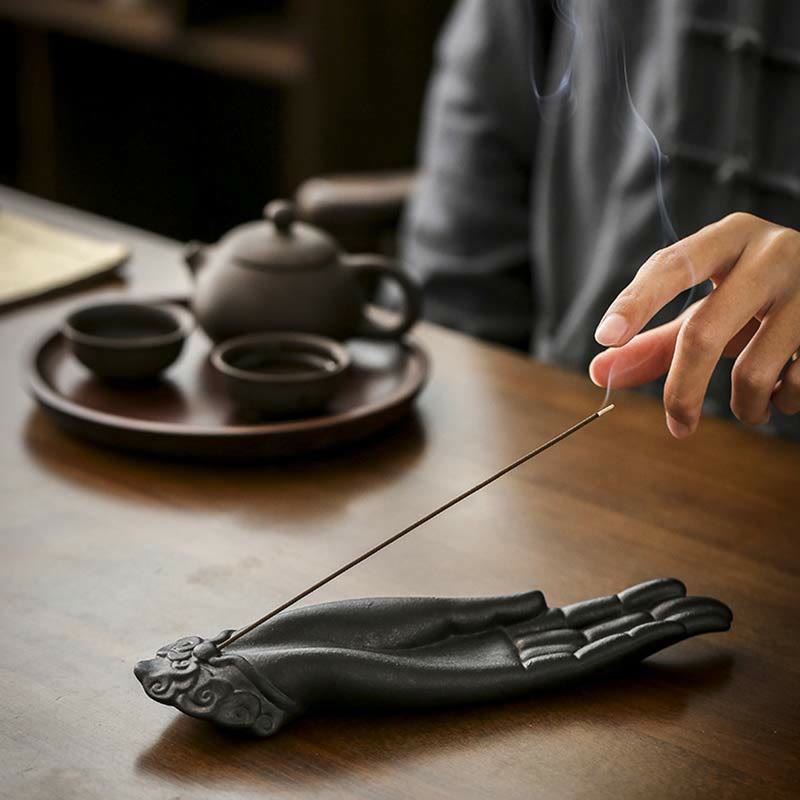 Buddha Hand Incense Burner – Yixing teapot set behind, smoke drifting toward reaching hand, peaceful