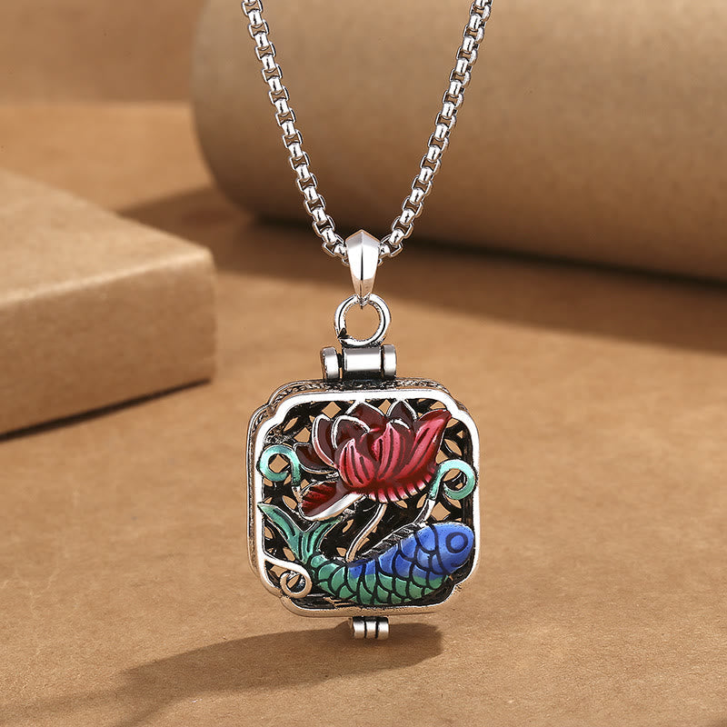 Koi Fish Lotus Ghau Prayer Box Necklace – locket from angle on kraft paper, red lotus blue koi filigree detail