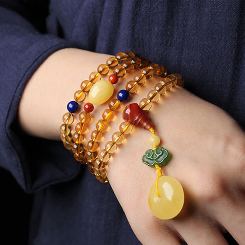 Citrine Mala Bracelet – Multi-wrap citrine mala bracelet worn on wrist with dark blue sleeve