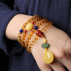 Citrine Mala Bracelet – Multi-wrap citrine mala bracelet worn on wrist with dark blue sleeve