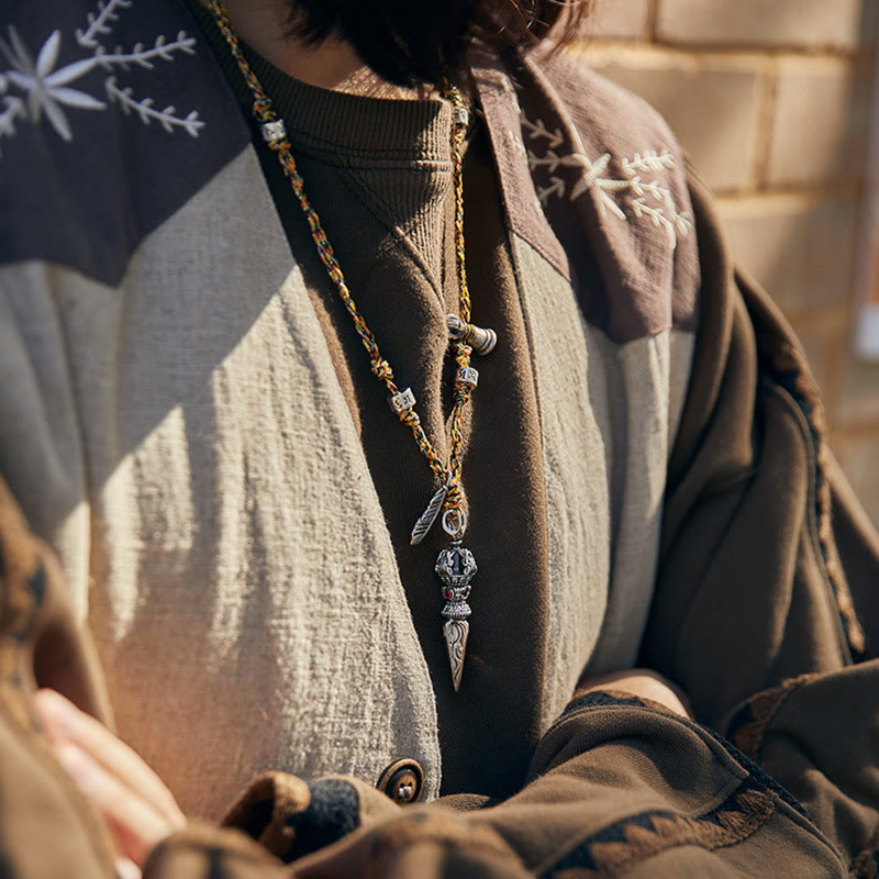 Dorje Vajra Pendant – Worn on model with embroidered jacket in natural light, boho spiritual necklace