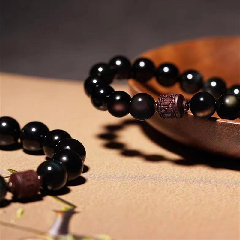 Gold Sheen & Rainbow Obsidian Fu Bracelet – on wood bowl with dried grass, obsidian bead jewelry