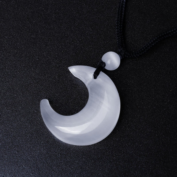 Silver Sheen Obsidian Yin Yang Pendant - White crescent moon with dramatic low-key lighting, crystal jewelry
