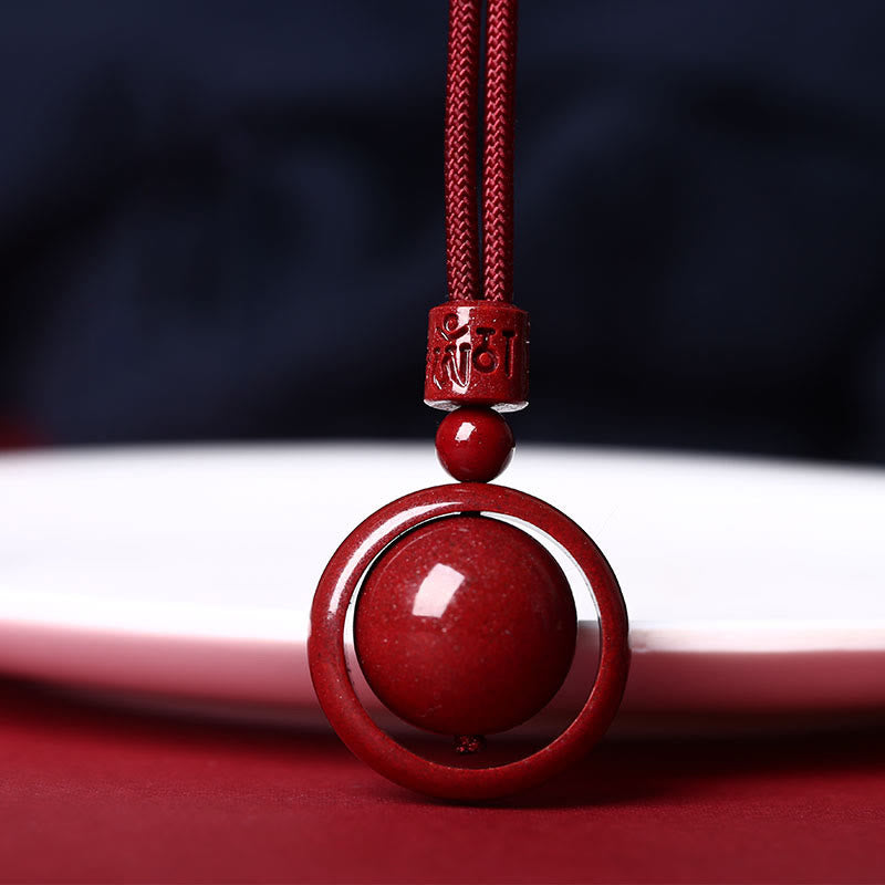 Cinnabar PiXiu Necklace – Front close-up red bead in circle pendant with mantra carving, cinnabar blessing jewelry