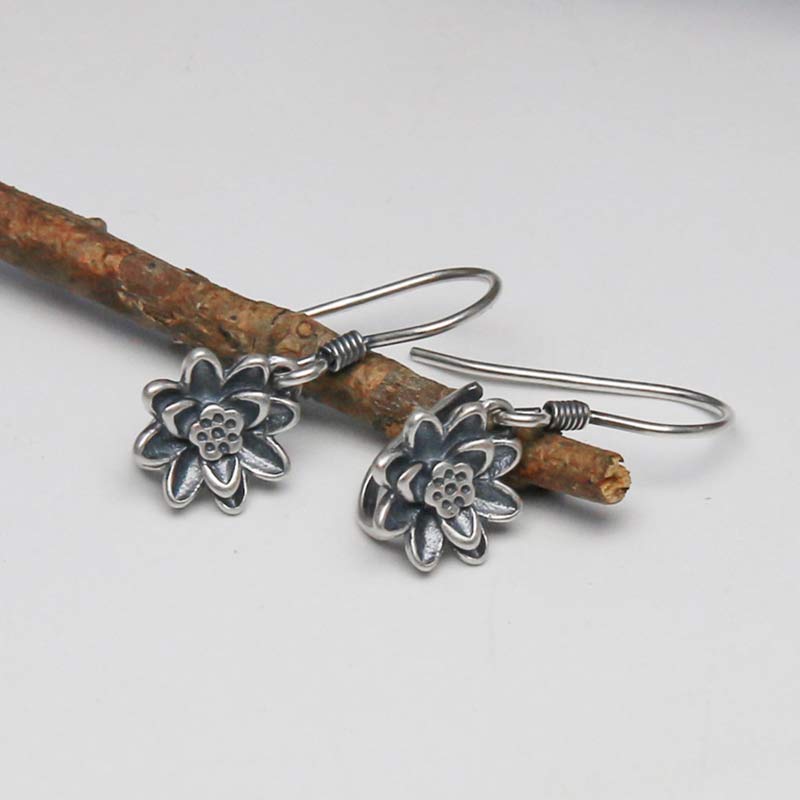 925 Sterling Silver Lotus Flower Enlightenment Earrings flat lay on natural branch