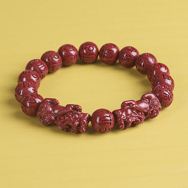 Double PiXiu Cinnabar Bracelet – Front view red cinnabar beads with detailed PiXiu carvings, wealth bracelet
