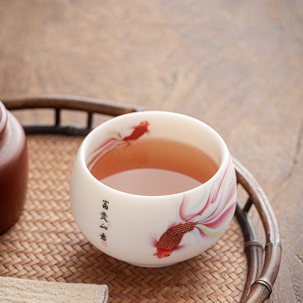 Koi Fish Ceramic Tea Cup - poured with tea showing liquid color against white interior