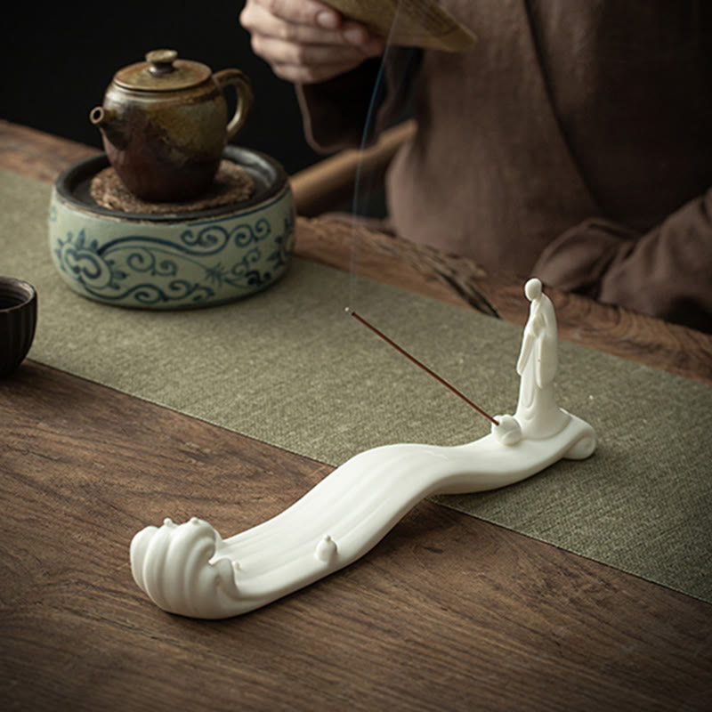 Buddha Monk Sea Wave Mountain Ceramic Incense Burner – Monk figure on flowing wave base with teapot fan and smoke, eastern aesthetic decor
