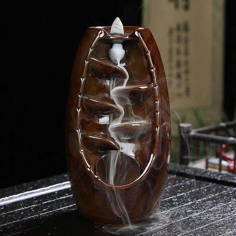 Tibetan Dragon Incense Burner – Glossy brown backflow with cascading smoke on stone slab, Luck