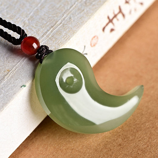 Yin Yang Jade Necklace – Green jade magatama pendant on black cord with red carnelian bead accent
