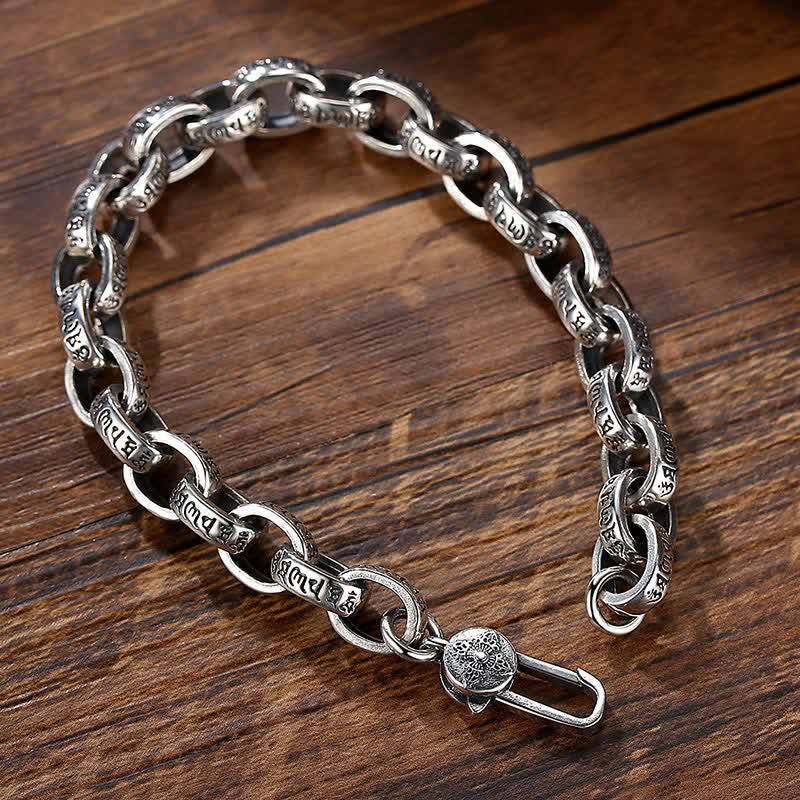 Silver Om Mani Padme Hum Bangle – Three-quarter view on wood, toggle clasp detail