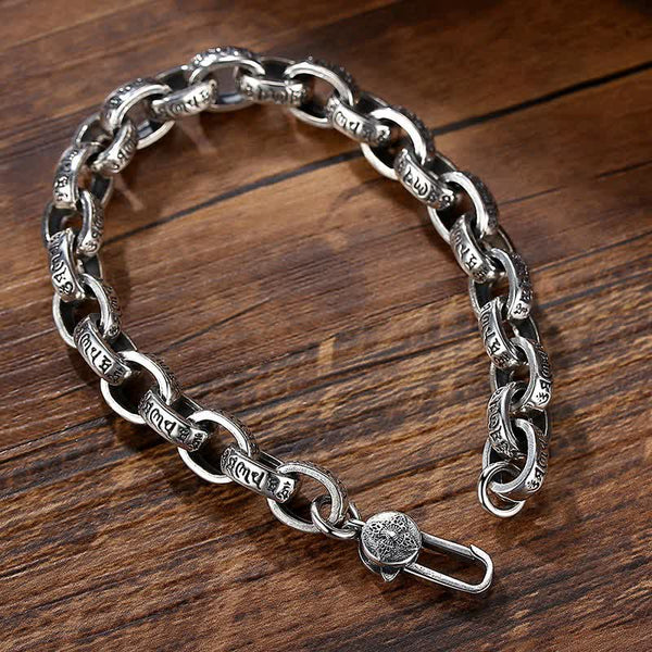Silver Om Mani Padme Hum Bangle – Three-quarter view on wood, toggle clasp detail
